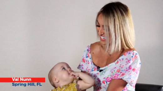 Woman looking down and smiling are her baby